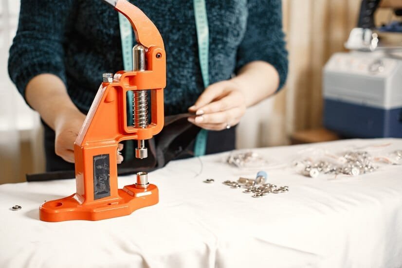 orange press clothes buttons fabric woman with sewing tools 1157 46476